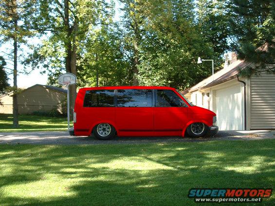 mikesvan.jpg my friends van.  i changed it to red, shaved the handles, lowered it, tinted the windows, clear lenses