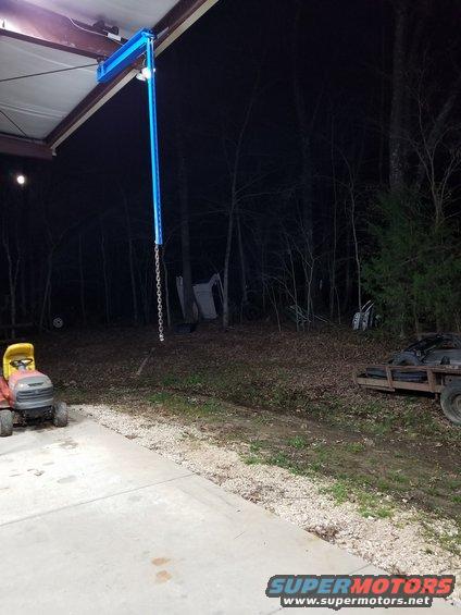 20190321_212126.jpg This light-duty pivoting boom should be strong enough for skinning deer & lifting lawn mowers, AFTER I add a brace to keep the red I-beam from twisting.  If that's not enough, I'll probably take it down.

It's made from a scrap of Aluminum I-beam (painted blue) with some welded reinforcements bolted to a rear wheel bearing & hub assembly that had started growling softly - it wasn't rumbling or sloppy yet.  The unistrut hangs from a wheel lug stud so that it's easy to remove.  It's just long enough that I can barely reach to hang it up there, so it's not likely that anyone else will be able to take it down.  But when I'm not using it, it will be inside.  The chain has a bolt to make a loop or shorten it, and there's also a hook on the end of the boom.

UPDATE: a beam trolley & 110VAC winch made this unnecessary, so it came down.  But I might put it up inside...