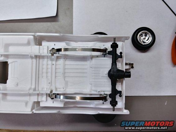 20190612_140210_hdr.jpg Checking the width of the springs with the axle. The original idea was to use the axle's original coil spring mounts to mount the leaves to it. Unfortunately, that will not work.