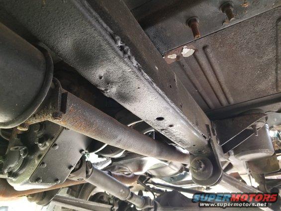 20190522_162949.jpg We still haven't figured out how the frame got dented here, under the RHF seat.  Apparently, many of the holes in the floor were taped before being flooded with Bondo.  Then, more steel was screwed, welded, & seam-sealed on top of the driver's floor (obscuring that body mount bolt).