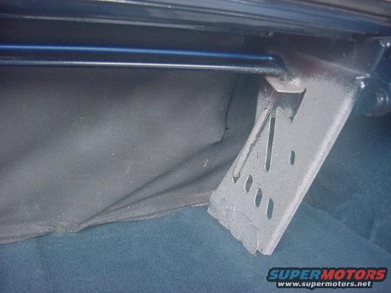 trunk-repair-002.jpg This view shows the right side, along with the tear that was made by the old rod shooting out of the bracket (my bad)