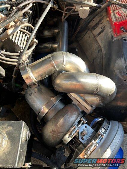 5-tacked.jpg All tack welded up and test fitting. I can move the header, turbo, and downpipe as a unit, but it is very heavy. It's hard to see but the down pipe ended up 1/4" from the corner of the head. Probably enough room if I wasn't thinking about wrapping the downpipe. I cut the tacks and slipped in a section of a pie cut set. It's 10 degrees. Looking at the aluminum mockup I could tell that there was a slight third bend. This should sort it out. But it got late, so more later. 