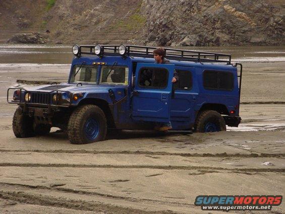 dsc00027.jpg This kid got his daddy's hummer stuck in some soft sand.  When he first got stuck he told US to walk over to HIM.  He finally came over and asked if he could use our winches, we told him no since we wanted to see a good show.  I big dodge finally yanked him out.