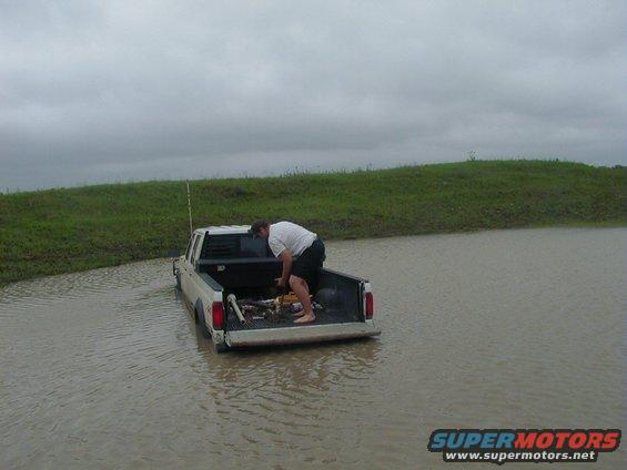 42904.2.jpg Thats me hookin the tow straps and stuff up on his truck the next morning after it rained really hard, so the water in the tank rose about 6-8 inches, and it was really really cold like 45-50 degrees and windy