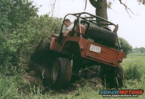 jeepfarm2.jpg With the coil set-up came fender trimming and lengthening the wheelbase