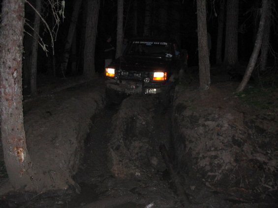 103_0307.jpg That night, some of the most fun and toughest trails.  This is Carey, ready to slide down near the end of the trail, over 7 hours after starting apx. 3 miles earlier on the trail.