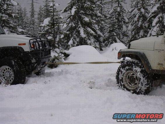 dscn3626.jpg Hummer H2 getting pulled out by the little Jeep :)