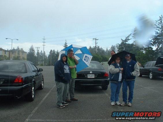 meet11.jpg 45 minutes later, another set of rain clouds come in. Linda and BJ keeping each other dry.