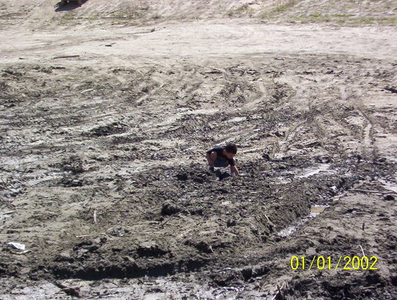 000_1460.jpg son playing in mud pit before to many trucks arrive.