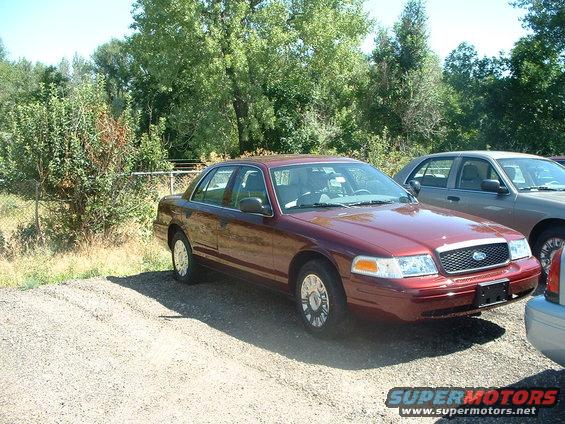 show-21.jpg Dark Toreador Red 2005 Crown Vic in line for equipment to be installed.