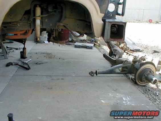 axle-gone.jpg Halfway thru swapping the worn-out '83 D44IFS for a nice '96 D44IFS.  The spring towers have already been swapped for the quad-shock type, and the '96 axle has the bottom mounts for the forward shocks.

[url=http://www.supermotors.net/registry/media/260055][img]http://www.supermotors.net/getfile/260055/thumbnail/rivetreplacement.jpg[/img][/url] . [url=http://www.supermotors.net/registry/media/255498][img]http://www.supermotors.net/getfile/255498/thumbnail/d44ifsusp.jpg[/img][/url]

On the drive home, I detected that the LHF caliper was seized, so I had to stop to buy a reman & some pads, and then change them at home.