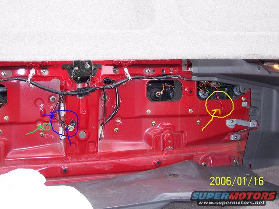 000_0115-modified.jpg Yellow circle/arrow shows the hot wire for lighted license frame.  Frame recently took in alot of water and kept blowing fuses, so I disconnected it.
Blue circle/arrow shows the ground connection.
Green circle/arrow shows where the wires enter from outside, behind the plate.
