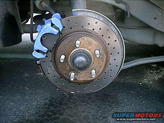 brake_1.jpg Rear passenger side shot of cross-drilled rotors and blue caliper.