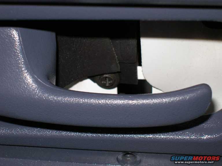 panel-removal1.jpg There is another screw behind the panel that surrounds the door handle . 