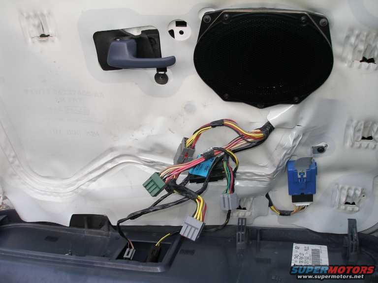 door-wiring.jpg Note the blue box, which is the auto down window unit. Also note the two wires in the lower portion of the picture that run to the fuel door and trunk opener. 