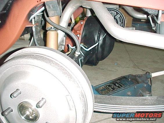 2005lhrearaxle.jpg Original Fomoco correctly dated brake drums. NOS Autolite Super Heavy Duty shocks in their distinctive copper color (Note: the assembly line shocks would have been black). The rear axle housing was sandblasted and painted with DP90. A new Detroit Locker was installed along with all new bearings and new Moser axle shafts. New Motorcraft brake linings and new AMK reproduction parking brake cables. 