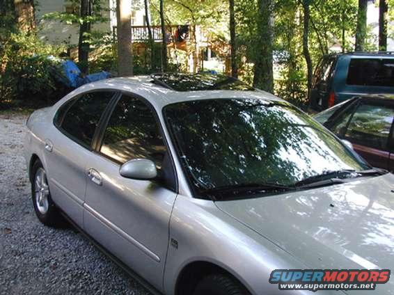 windows.jpg Here is another shot of all the windows.  Also shows tinted sunroof (5% limo tint).  The front window is not tinted, but looks that way due to the reduction of light inside the car and the shadow of the overhead tree.