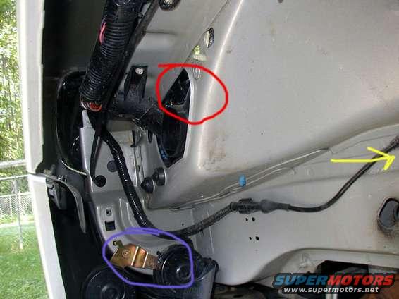 fenderwellmarked.jpg The red area is the air intake.  This is where the silencer was bolted.  For reference, the blue cirle is one of the two horns.  The yellow arrow points to the rear of the car (the shock is just to the right of this picture).