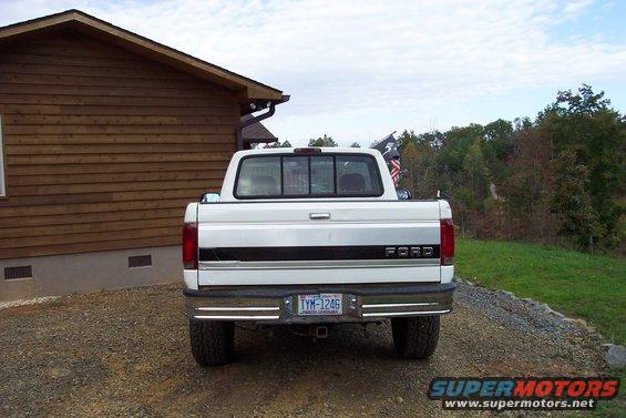 100_0964.jpg Rear view, about a week after I got the truck, in this picture it shows the bent down rear bumper and part of the bed caps and bed liner I have removed.