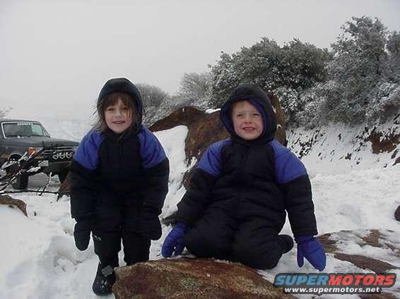 cole_and_jenna_pose_on_rock_ion_snow.jpg 