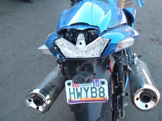 dscf0071.jpg I can still hear the sound of this plastic breaking before I was thrown off of the bike.  Like my personalized plate?  It reads "Highway Bait".  A nice shiny motorcycle works as a better lure for DPS Officers then donuts do.