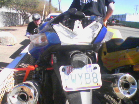 picture052.jpg I think my wife likes my personalized license plate.  In the background facing the camera is PJ, and on the trailer is Eric, also a PMRG member.  Both of them were so kind to help my wife get the bike to the dealer.