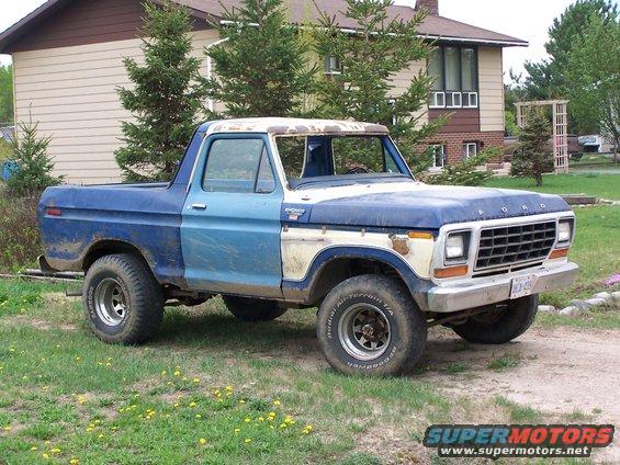 100_2846.jpg My truck before doing the body work.  Prity much how I got it except the light blue door and the 33's