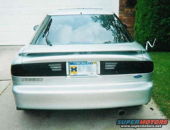 scan0001.jpg I now have the GT bumper (after being rear ended)  and black backgrounded ford logos on the front and back... also aqua neon under the back...  if I get a digital i will take more pics