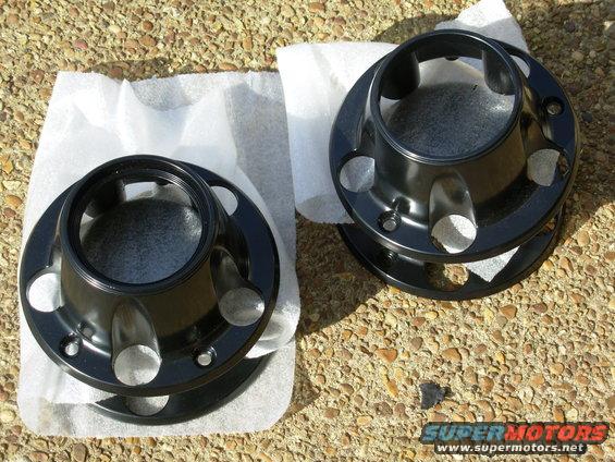 bkcenters.jpg Black Powdercoated Original-Equipment Hub Center Cap Set

2 front 4WD; 2 (rear, or 2WD front) without center medallion
These still have (scuffed or sandblasted) chrome under the powdercoat.  Glue your original rear centers into these using RightStuff, E6000, black silicone, etc.