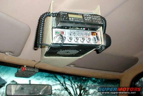 cb_mount.jpg My overhead console is made of 2 pieces of sheet metal.  The first one (visible around the scanner) is screwed to the roof.  The second is covered in 1/8&quot; foam & cheap duck canvas from Wal-Mart, and it hangs on the upper w/s trim & 2 screw heads on the 1st piece.  It took a few hours to mock up in cardboard, then lay out on the metal & cut out with snips, drill a few holes, & bend into shape.  I used 3M spray adhesive to apply the upholstery.

The radar detector mount is bolted through the windshield trim.