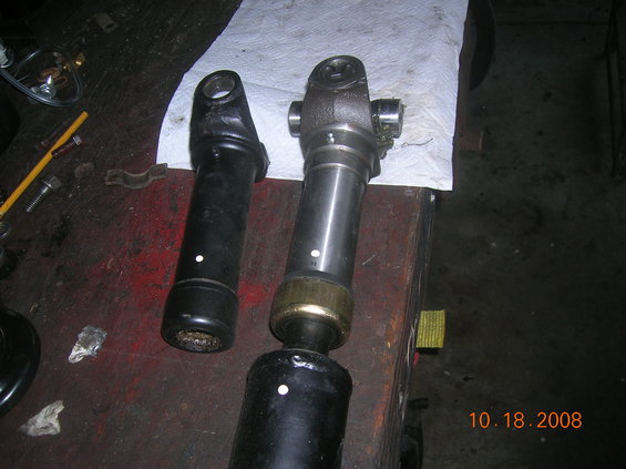 dscn2866.jpg drive shaft reworked with a 1350 u-joint...next to it is the stock size.