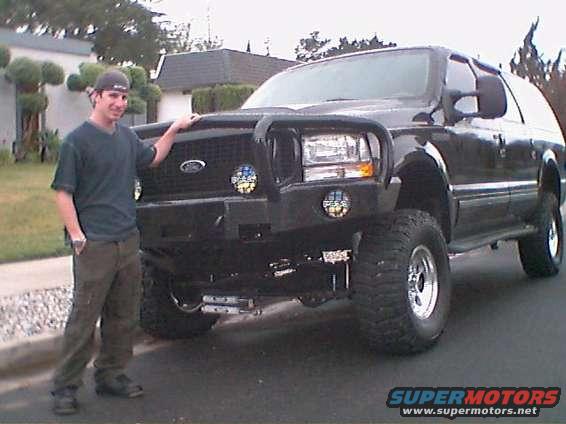 lift_corner.jpg After the lift, showing the RoadArmor bumper, 2 pair of PIAA lights, new steering stabilizer system, 35" Pro Comp X-Terrain's and Pacer wheels.