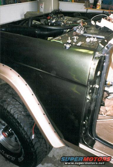 k4.jpg Bushwackers, Crown Vic intake, & driver's vent blockoff plate.  The connector hanging in the wheelwell is for the power antenna.  Note that the Rhino Lining extends to the threshhold.

The colors are 2000 Eddie Bauer Expedition Estate Green & Light Prarie Tan.