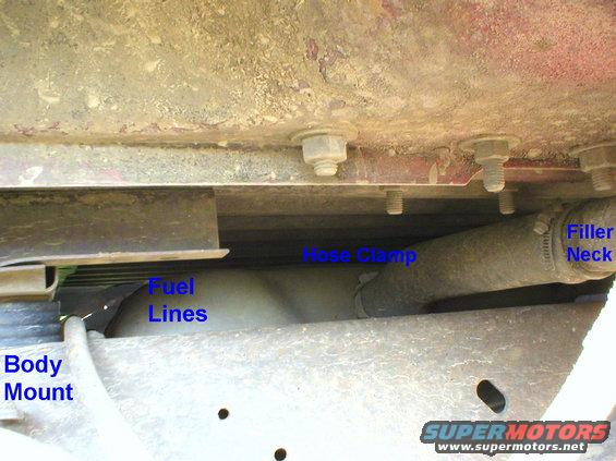 filler.jpg Filler Neck
Loosen the hose clamp at the tank & pull the outer filler neck off the tank.  There is another hard plastic hose inside ('87-96), which also must be guided out of the tank.

The extra bolts in the body are for the dealer-option 3rd-row jump seats & belts.

For pickups, see this & the NEXT dozen:

[url=http://www.supermotors.net/registry/media/853031][img]http://www.supermotors.net/getfile/853031/thumbnail/40fillerpipe.jpg[/img][/url]