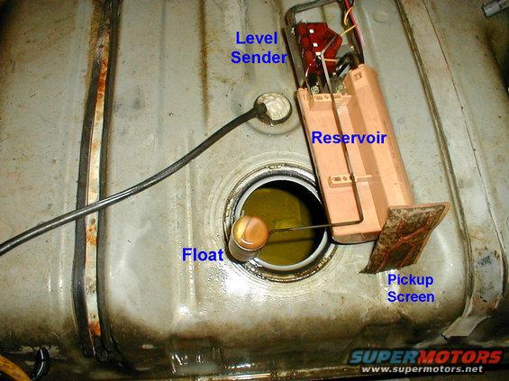 j-3.jpg FDM Removal
Once the lock ring is removed, break the O-ring seal & lift the FDM from the tank.  The reservoir will spill, and the pickup screen will spray fuel as it comes out.  The O-ring should never be re-used.

That white object in the tank behind the float arm is a piece of silicone that somehow found its way into my tank.  There are a few others in there, and occasionally, the truck would stall when they got pulled around the pickup filter, and blocked the flow of gas into the pump.  I guess vandals stuffed them into the pump nozzle at the gas station.

To temporarily or permanently convert a '90-up 2-tank truck to a single tank, read this caption:
[url=http://www.supermotors.net/registry/media/862974][img]http://www.supermotors.net/getfile/862974/thumbnail/76solder.jpg[/img][/url]