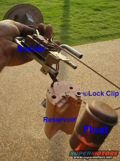 module-1.jpg Reservoir Removal
Remove the level sender upper mounting screw, press & hold the lock clip down, then lift the tube assembly from the reservoir.

The reservoir (which contains the pump, the return valve, & the pickup siphon) is interchangeable between all '90-96 rear gasoline tanks.  The pump (not visible inside the reservoir) is the same for all '90-96 gas trucks & tanks (maybe even diesel).  The tube & plate assembly in my hand is specific to '90-96 Broncos, and its pigtail connector is specific to '94-96.  The sender is compatible with all '87-97 gasoline trucks; the arm fits '87-96 Broncos; the float fits virtually all truck rear tanks, and some front tanks.  The wiring unplugs from the tank plate, and from the motor.

To temporarily or permanently convert a '90-up 2-tank truck to a single tank, read this caption:
[url=https://www.supermotors.net/registry/media/862974][img]https://www.supermotors.net/getfile/862974/thumbnail/76solder.jpg[/img][/url]