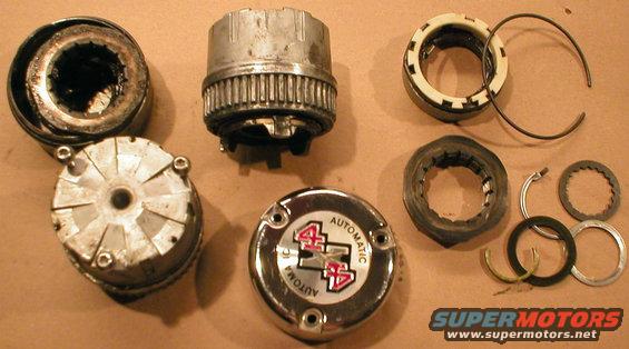 hubautolocks.jpg 3-screw Warn Automatic Hub Locks ([url=https://www.amazon.com/dp/B004M68EU6]F6TZ-1K105-AA[/url])

The 2 items at the far L are one complete hub lock assembly piled together.  The top center is the hub lock body.  Bottom center is the cap with 3 screw holes. Top R are the friction ring & large (outer) C-ring (which retains the lock body in the hub).  Lower R (upper row) are: the 2.5-inch single wheel bearing adjusting hex-nut; the adjusting nut lock clip; the steel splined thrust washer; (lower row) the small (inner) C-ring (which retains the axle stub shaft in the spindle); the plastic thrust washer; and the steel thrust washer.  Refer to this:
[url=http://www.supermotors.net/registry/media/277564][img]http://www.supermotors.net/getfile/277564/thumbnail/hublockauto95up.jpg[/img][/url]

There should never be a need to disassemble the hub lock body any more than this, unless it has been severely neglected or abused. DO NOT pack the lock with grease - a light coat is enough; any more will jam the mechanism. The correct way to clean & lube an auto hub lock is to dunk it in ATF each time the wheel bearings are serviced (which should be FREQUENTLY if the truck is used off-road; or every 30Kmi if it's not).

See the NEXT pic, and:

[url=http://www.supermotors.net/registry/media/470473][img]http://www.supermotors.net/getfile/470473/thumbnail/tsb970628motoringtorque.jpg[/img][/url]