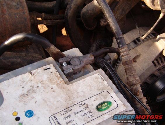 08fin.jpg The cooled & wire-brushed terminal is now installed on the cleaned battery post, making a connection that will last for years with no further maintenance.  The clamp bolt is tightened ONLY enough to prevent the terminal from being twisted on the battery post by hand.  Although this terminal's copper construction makes it MUCH stronger than a lead terminal, it can still be damaged by overtightening.  Overtightening is merely a compensation for a poor connection, and this one is already as good as can be had.  Grease & sprays are not necessary, and will not make the joint more reliable.  But the correct grease would be Electrical Grease such as MotorCraft XG-12 (NOT dielectric, thermal, chassis, white lithium, anti-seize, or red slime battery spray).

Attaching the winch ground cable as shown is NOT ideal, but I haven't decided yet how to route the cables.  Since solder is easy to melt & reattach, this is NOT the permanent arrangement.

Finally, check the ALTERNATOR, frame, & block ground connections, as described here:

[url=http://www.supermotors.net/registry/media/825495][img]http://www.supermotors.net/getfile/825495/thumbnail/cont6.jpg[/img][/url] . [url=http://www.supermotors.net/registry/media/825375][img]http://www.supermotors.net/getfile/825375/thumbnail/alternatormountboss.jpg[/img][/url] . [url=http://www.supermotors.net/vehicles/registry/media/770502][img]http://www.supermotors.net/getfile/770502/thumbnail/02groundframe.jpg[/img][/url] . [url=http://www.supermotors.net/registry/media/828671][img]http://www.supermotors.net/getfile/828671/thumbnail/battstartwire9296.jpg[/img][/url] . [url=http://www.supermotors.net/registry/media/955475][img]http://www.supermotors.net/getfile/955475/thumbnail/26winchrelays.jpg[/img][/url]

See also:
[url=https://www.supermotors.net/registry/media/1161048][img]https://www.supermotors.net/getfile/1161048/thumbnail/battbrands.jpg[/img][/url] . [url=http://www.supermotors.net/registry/media/830812][img]http://www.supermotors.net/getfile/830812/thumbnail/mdxp300.jpg[/img][/url] . [url=http://www.supermotors.net/registry/media/849623][img]http://www.supermotors.net/getfile/849623/thumbnail/51batterytender.jpg[/img][/url] . [url=http://www.supermotors.net/registry/media/1035425][img]http://www.supermotors.net/getfile/1035425/thumbnail/g103v8.jpg[/img][/url] . [url=https://www.supermotors.net/registry/media/1158869][img]https://www.supermotors.net/getfile/1158869/thumbnail/20200329_144339.jpg[/img][/url]
[url=http://www.amazon.com/dp/B000O0QLD6/]Motorcraft F2TZ-14301-B[/url] Negative Battery Cable with body, frame, & block grounds
___________________________________________________
&quot;Grounding&quot; is commonly misunderstood...

When electricity first became publicly available (when Edison & Tesla were fighting over DC vs. AC), Copper wire was very expensive. So rather than run 2 wires everywhere, Tesla realized he could run a &quot;hot&quot; wire, and then use the ground (the actual dirt of the Earth) as the return circuit path. (He also thought he could use the ionosphere as the hot side, but he never got that to work.)  Inside a house, there still had to be 2 wires, but one of them went &quot;to the ground&quot; via a Copper rod driven into the dirt outside the house. That became known as &quot;the ground wire&quot;. When vehicles acquired electric circuits (AFAIK, the first on any Ford was the electric horn, which Ford always numbers as circuit #1), it was equally-efficient to use the metal chassis of the vehicle as one the main electrical pathway, to reduce the amount of wire needed. And the term &quot;ground&quot; was carried over into that arena. Chassis grounding worked reasonably-well until alternators got up into the ~100A range (in the 80s) and vehicle wiring harnesses began to exceed the weight of the drivetrain (AFAIK, the first to cross that line was the '92 Lincoln Continental V6). Since then, more circuits are networked through high-speed data bus lines via communication modules so that you don't need a discrete wire running from one end of the vehicle to the other & another coming back to turn on a taillight, and confirm that the bulb isn't burnt out.

But as a result, the chassis/body ground is no longer sufficient to provide a reliable circuit path without introducing a lot of background noise (RFI) into those minuscule high-frequency data signals. So the trend for a couple of decades now has been to run actual Copper return wires so that far less current flows through the chassis steel. (House wiring standards added a return &quot;neutral&quot; wire decades before that.)

So by definition, if you're using a wire to return to the battery, you're not &quot;grounding&quot; that circuit - you're wiring it. And wiring it is a good idea when you're dealing with rusty 40- to 50-year-old body & frame steel. The catch is that the return wiring has to be AT LEAST as large as ALL the power wiring that it serves - IOW, very big like the alternator output wire, the starter wire, the winch wiring, and the ignition switch battery-supply wires. None of it needs to be bigger than the battery cables because you can't ever get more current flowing than the battery can put out (roughly whatever its CA rating is).

So if you want to be sure you have a good return path throughout any vehicle, just extend the battery (-) cable all the way to the trailer connector. Obviously, you can't run a cable that big into the trailer connector or anything else - you have to splice onto it to branch off with smaller black wire (or whatever color the particular circuit uses for &quot;ground&quot;). That's why I refer to that as a &quot;trunk ground&quot; system - the main return wire is like a big tree trunk, with the variously-sized smaller branches shooting out to hit each point on the vehicle that needs an exceptionally-reliable return (generally: the high-current devices; and those that require low RFI noise, like audio amplifiers).

Fortunately, those splices DON'T need to be insulated - they can be left showing bare metal. Copper & solder don't corrode very quickly in air, or even in common rainwater. Mainly just at the battery where acid leaks out. Road salt will eventually cause some corrosion, but probably not enough to matter within the remaining lifespan of even the best-maintained antiques.

And the body & frame should still be GROUNDED at a few points, just to reduce galvanic corrosion, and to serve the very-low-current chassis-grounded loads like taillights & fuel level senders.