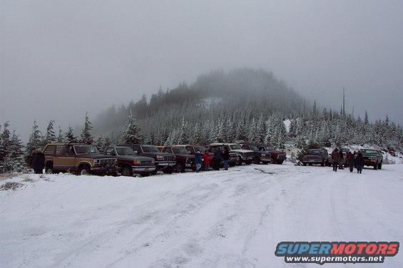 dcp_0203.jpg Here we are at the top all lined up for a picture.  Count'em, 1, 2, 3, 4, 5, 6, 7, 8, 9, 10, 11, 12 rigs.  1 F250, 1 F150, 1 Bronco II, 1 Explorer and 8 Big Broncos.  More trees harvested, a late lunch break, and chain removal before heading down the other side, which as it turns out was very slick and the chains would have been helpful.  Never the less we all made it down safe and sound.