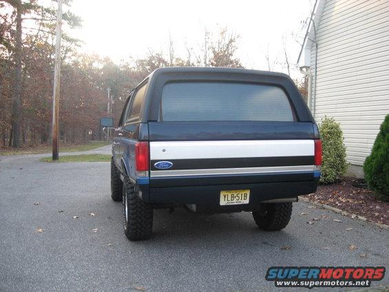 004.jpg New tailgate..thanks C4C......welded up the spare mntg bracket holes & dents..reshot w/ SS urethane. 
Rollpan added, but first had to modify to close up gap to tailgate. No plans to add light blue stripe under XLT trim.....yet. New fuel tank & skid plate visible...Class4 hitch still in barn. 