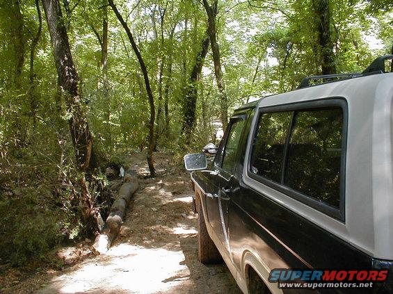 logwinch.jpg A few minutes ago, the log on the L was blocking the trail.  I used the winch to break it and move it out of the way.