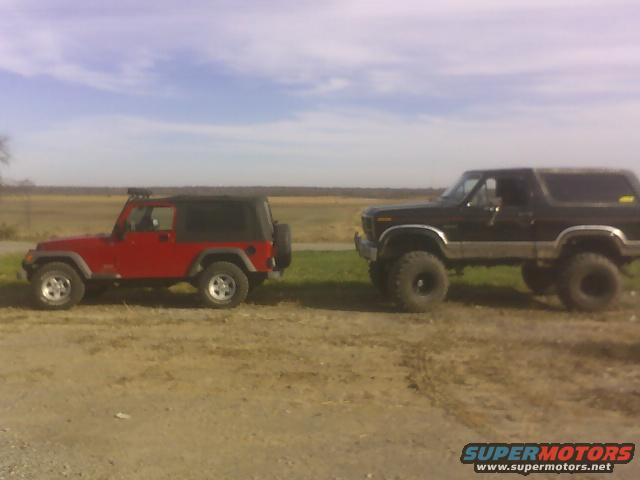 broncenstien2.jpg 2" lifted jeep in front of the beast