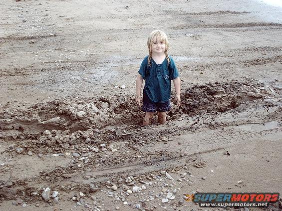 imag0026.jpg my daughter standing in the whole notice the transfer case skid plate hit.