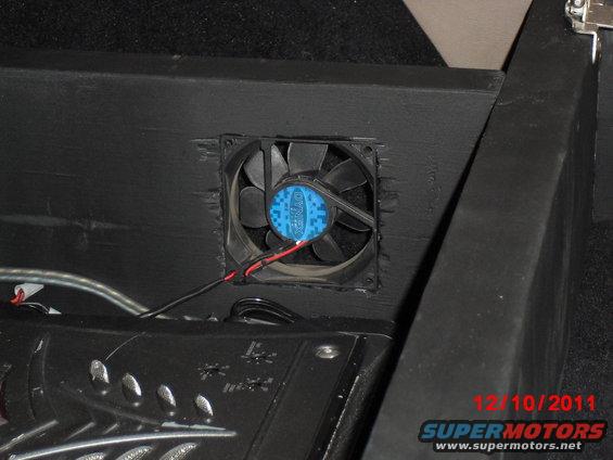 cimg7253.jpg A computer fan for cooling the amps; forgive the rough finish around the hole, but all I had to do it with at the time was a rotary cutting tool