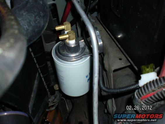 aux-trans-filter-install-018.jpg Even though this filter is mounted way up and out of harms way, I can fill the filter with Mercon V and reach in through the engine compartment and spin it on with room to spare and not drip a drop!!!