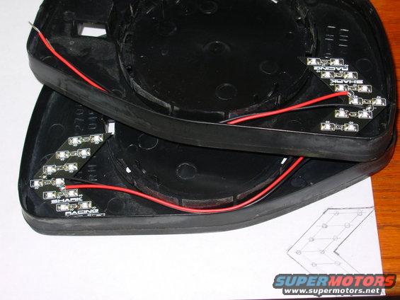 shark01.jpg Since factory signal mirrors are so hard-to-find, building them is another option.  These LED chevrons were made by [url=http://www.sharkracing.com/acecart/bin/shop.cgi?action=view&itemID=ledmirrordiy&cate=070000000]Shark Racing[/url] (back in 2012, now [url=https://www.ebay.com/sch/i.html?_from=R40&_trksid=m570.l1313&_nkw=2x side mirror %28turn%2Csignal%2Carrow%2Cchevron%2C14smd%29&_sacat=6000]from many eBay sellers[/url]), and are specifically built for this purpose.  They recommend mounting them between the backing plate & the glass.  But because it's nearly impossible to separate the mirror from the plate without destroying either of them, and because putting them there doesn't make them directional, I'm putting them on the backs of the plates.  First, I powered one and created a paper template by silhouette.

READ THE NEXT CAPTION...